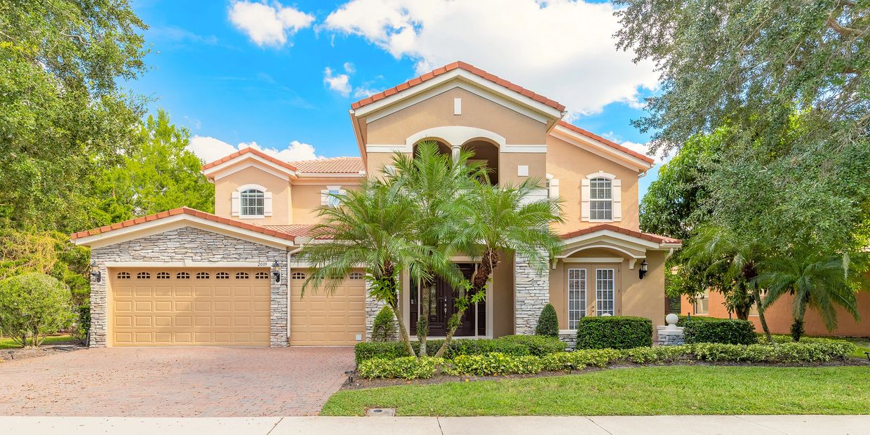 Front exterior of luxury gated pool home in Winter Garden, FL