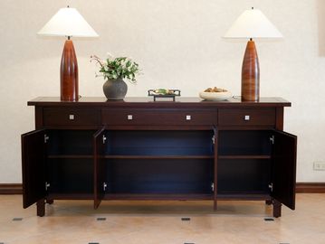 Dark wooden sideboard with open cabinet doors and decorative items on top.