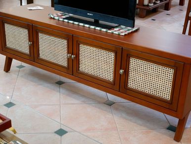 Wooden TV stand with woven cane cabinet doors.