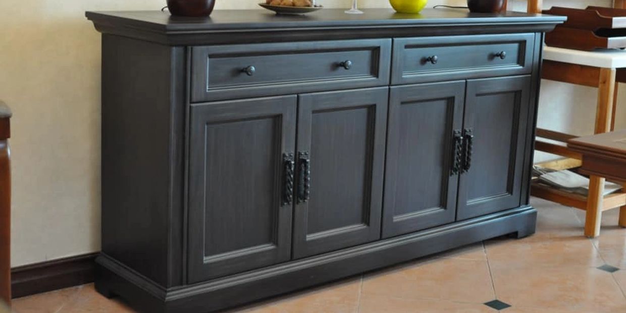 A dark wooden sideboard with drawers and cabinets.