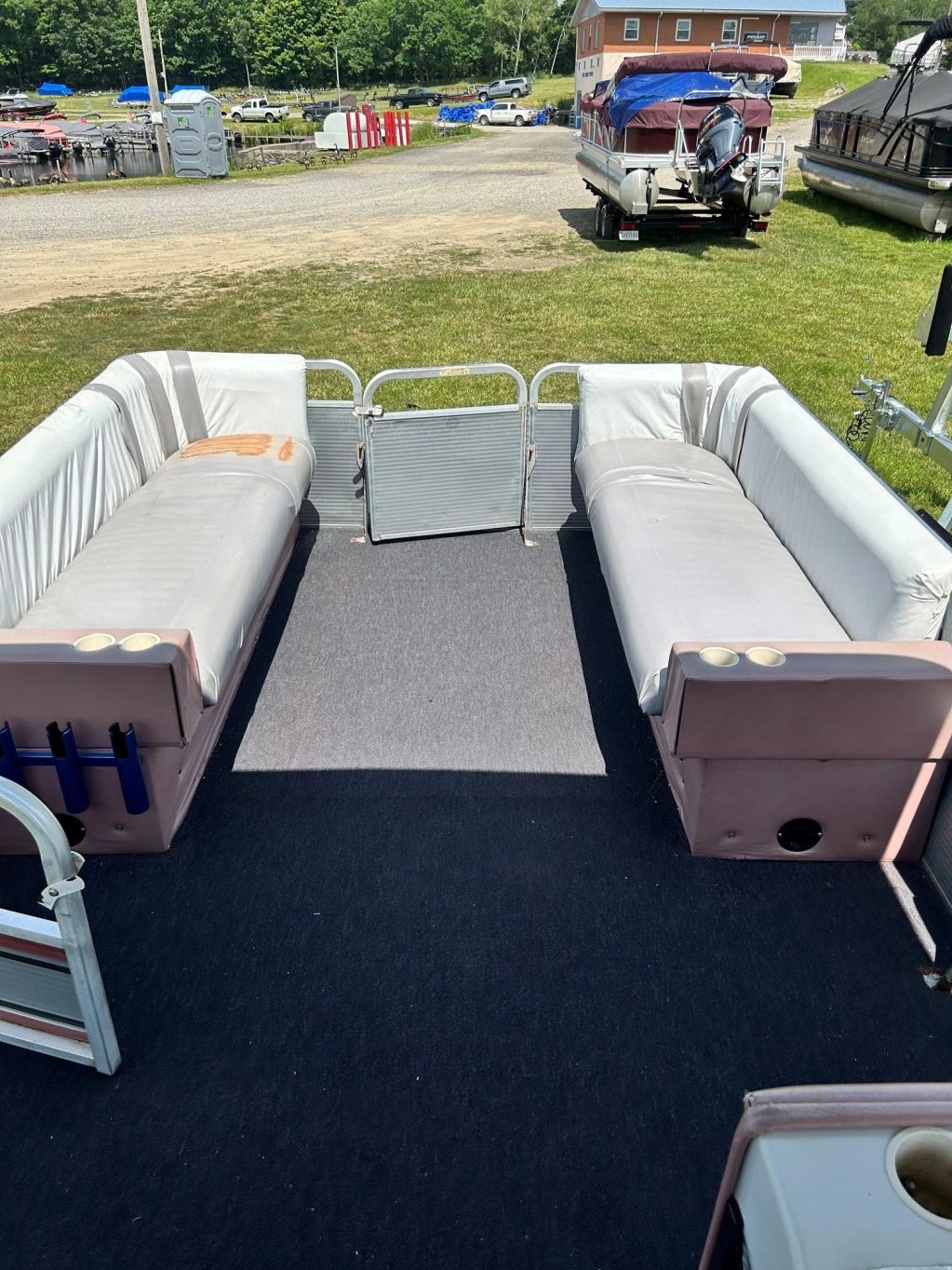 Interior seating area of a pontoon boat with two benches.