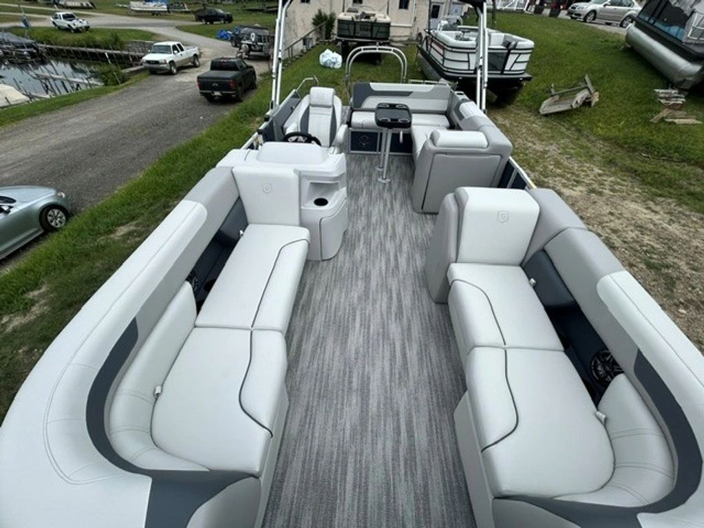 Spacious pontoon boat interior with grey and white seating.
