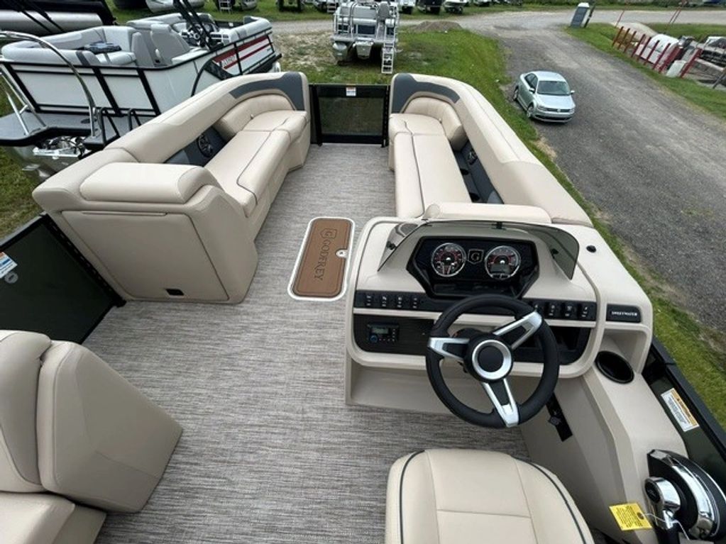 Interior of a stylish pontoon boat with beige seating.