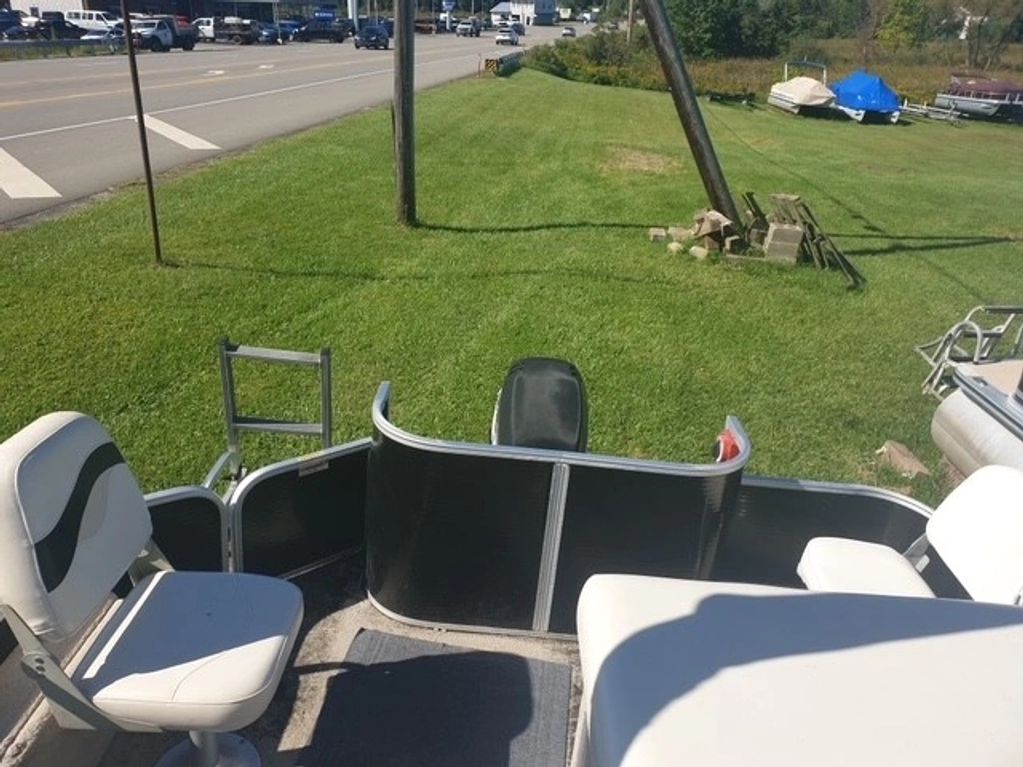 View of a boat deck facing a grassy area and road.