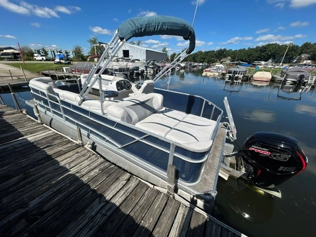 Pontoon boat docked on a sunny day.