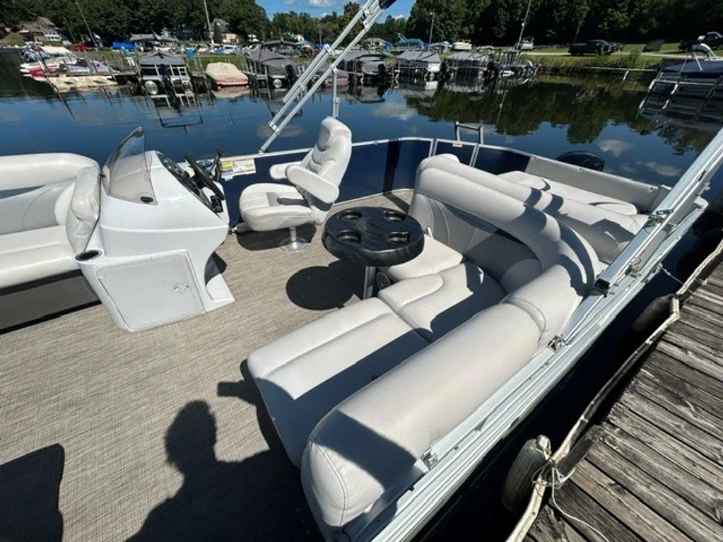 Spacious pontoon boat seating area with lake view.