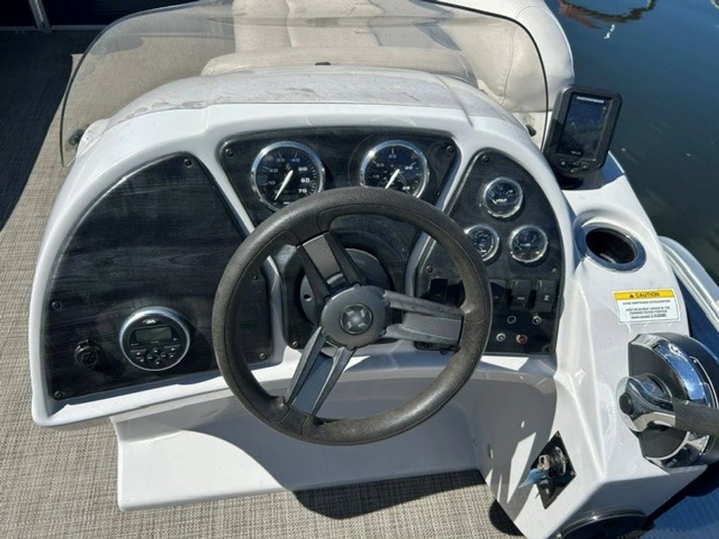 Boat steering console with gauges and controls.