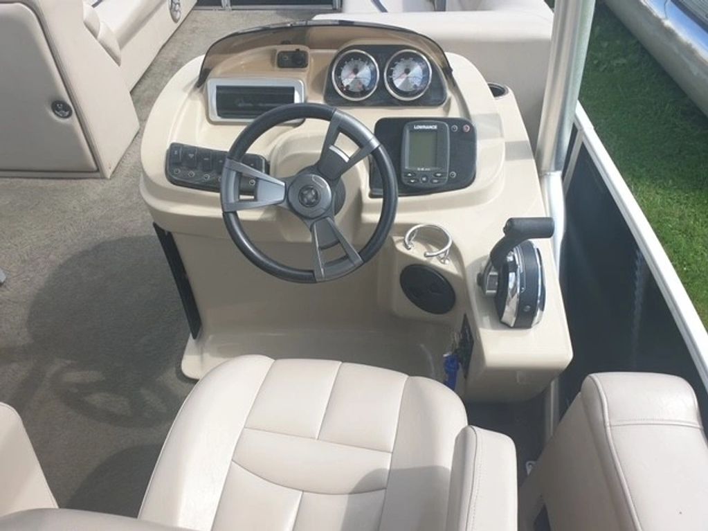 Boat helm with steering wheel and controls.