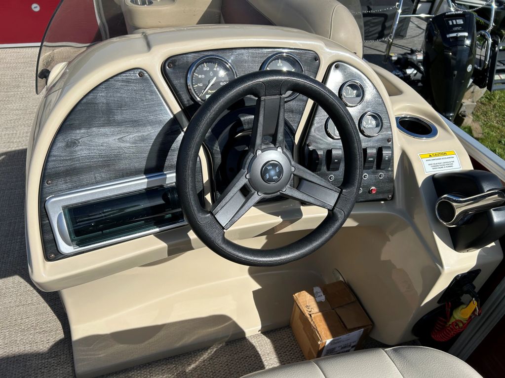 Boat steering console with gauges and controls.