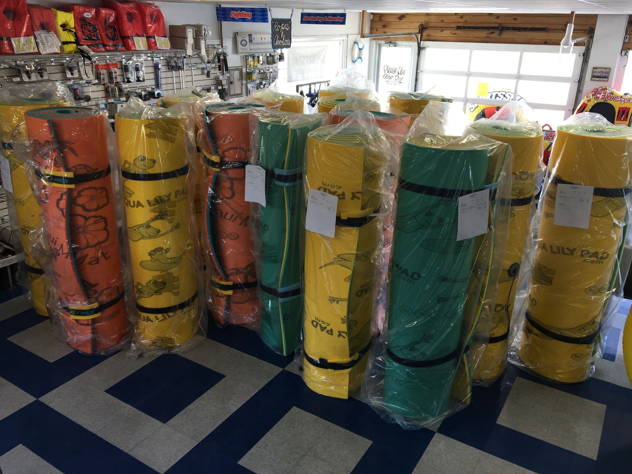 Rolled-up colorful foam pads wrapped in plastic in a store.