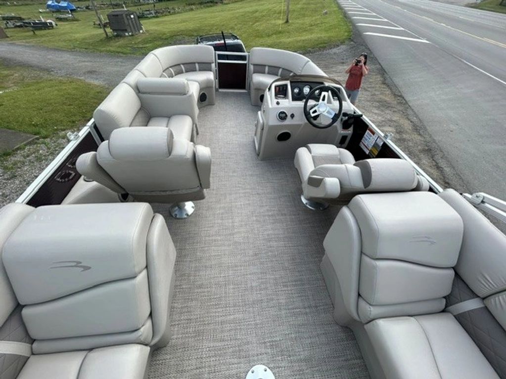 Interior view of a pontoon boat with beige leather seating.