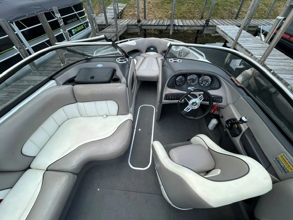 Interior of a sleek motorboat with comfortable seating and steering wheel.