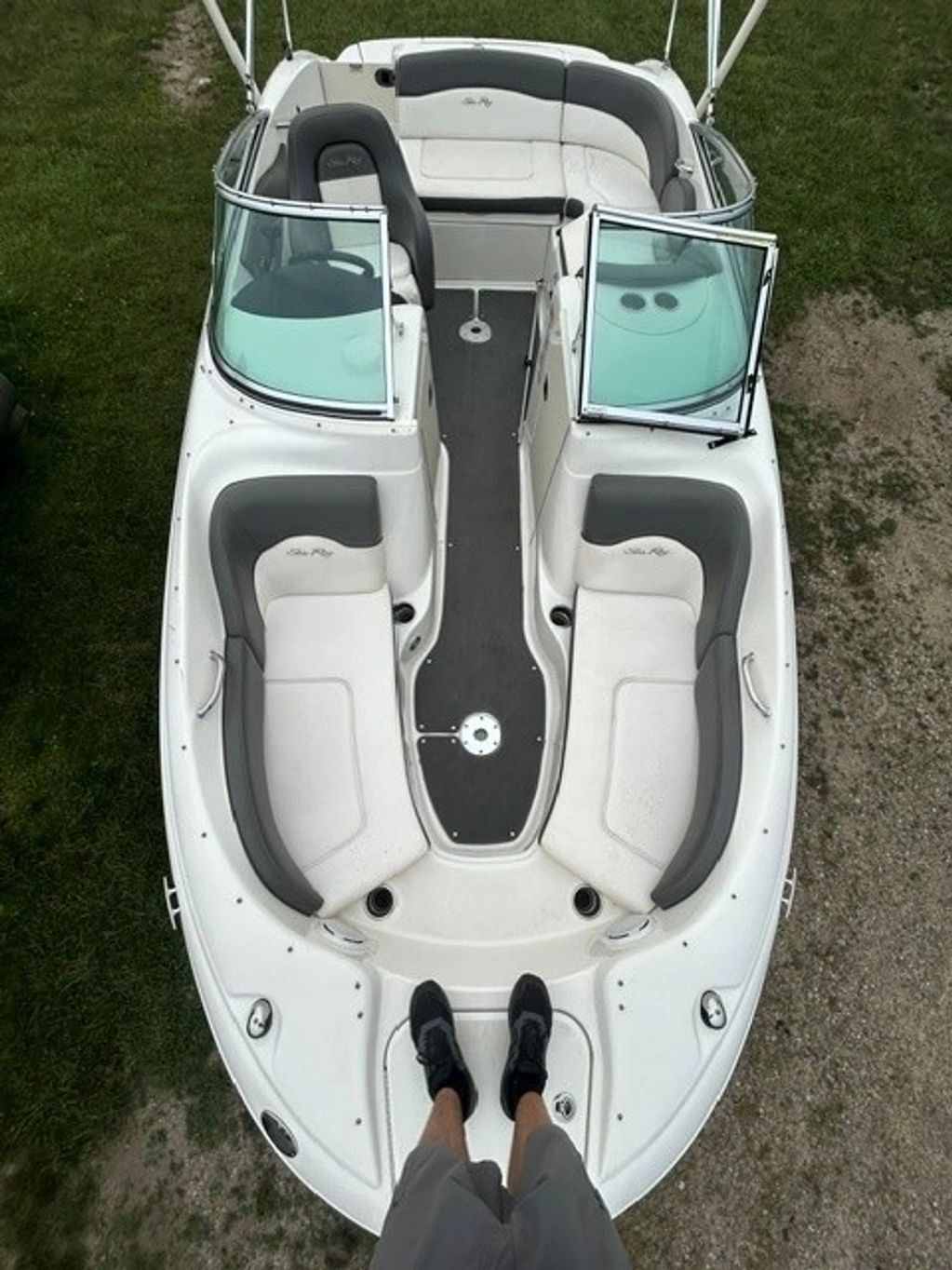 Empty Sea Ray boat interior with gray and white seats.