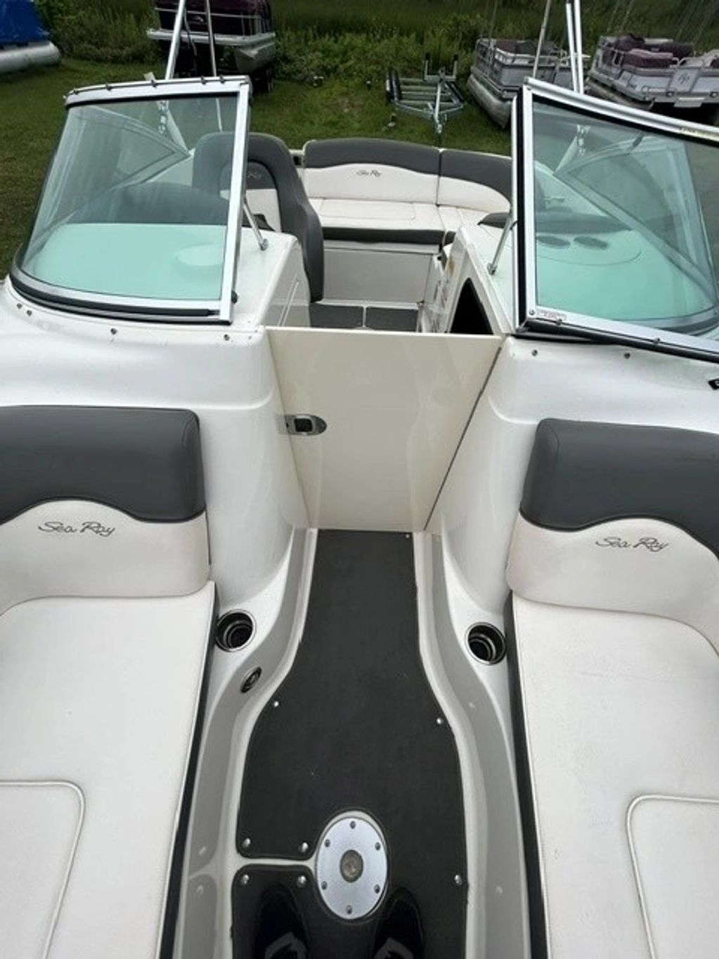 Interior of a Sea Ray boat with white and gray seats.