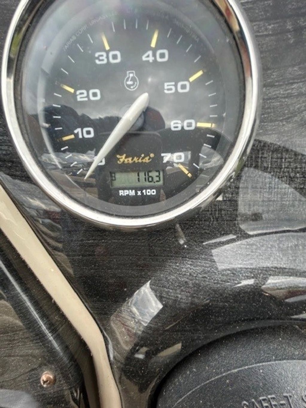 Close-up of a Faria RPM gauge showing 1163 RPM.