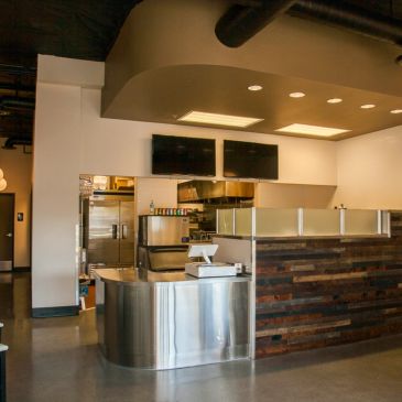 Empty modern restaurant counter with stainless steel and wood finish.