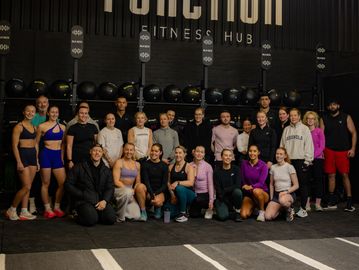 A group photo of people at a fitness hub.