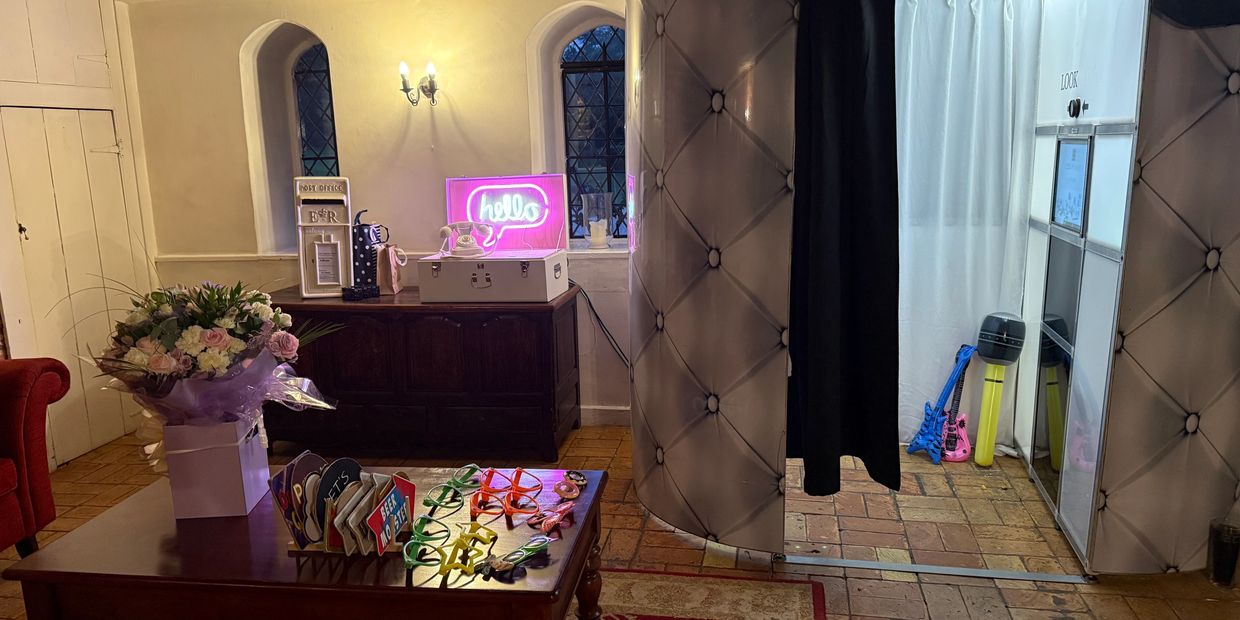 Cozy room with photo booth and colorful props for fun pictures.