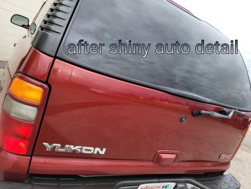 Shiny red Yukon SUV after auto detailing.