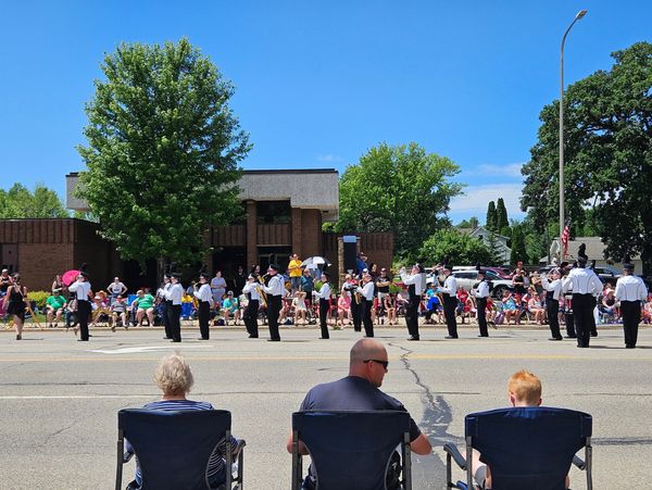 photo of Alexandria High School marching band in a parade on Broadway Street