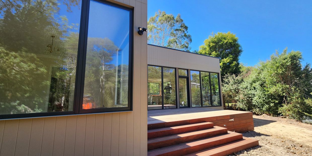 Builders cleaning completed house - exterior view
