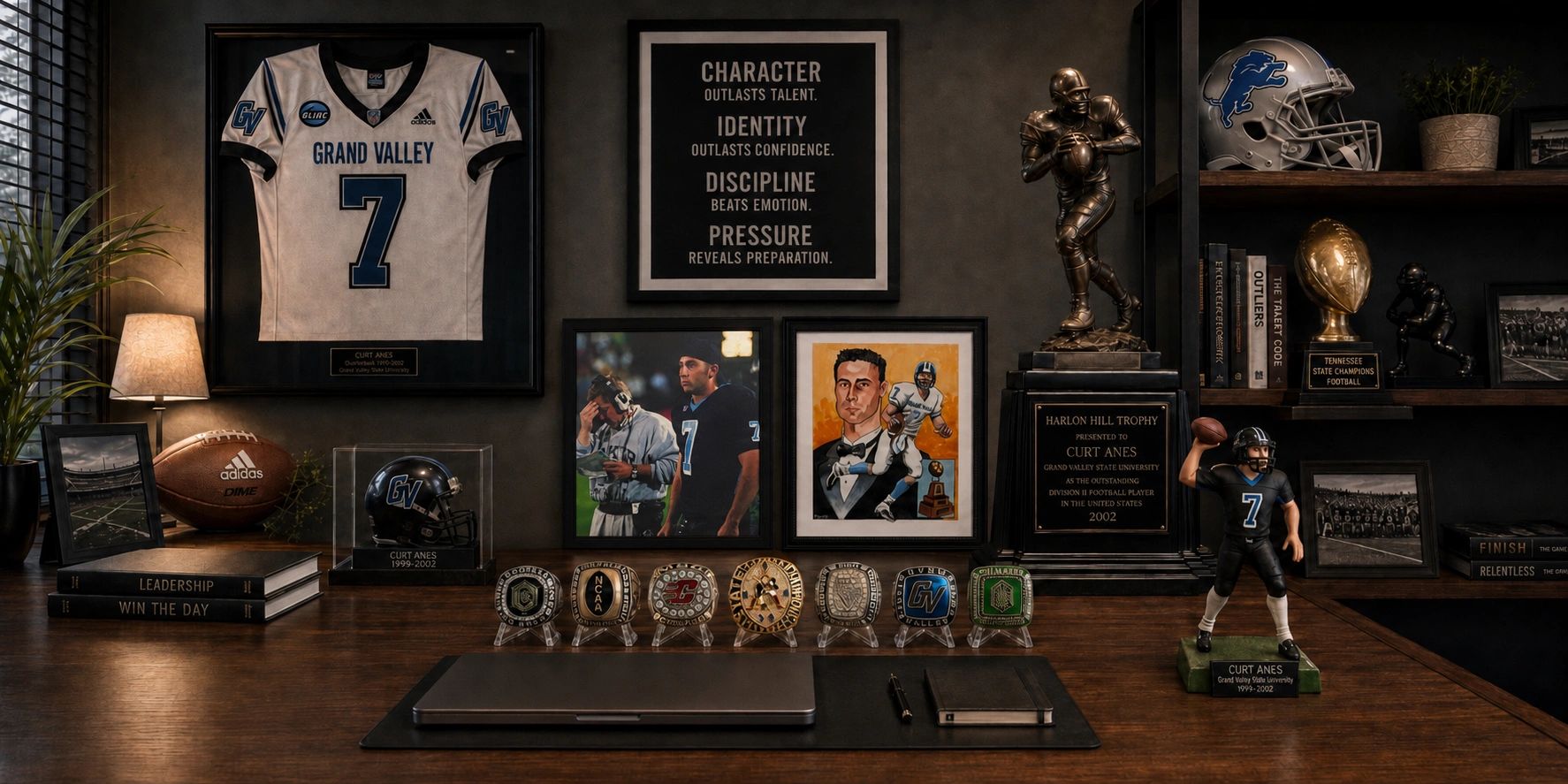 Curt Anes GVSU Quarterback desk displaying football memorabilia and trophies.