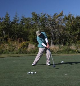 Greg Lavern Author Of Finish To The Sky  Golf Instruction  demonstrates a solid impact position . 