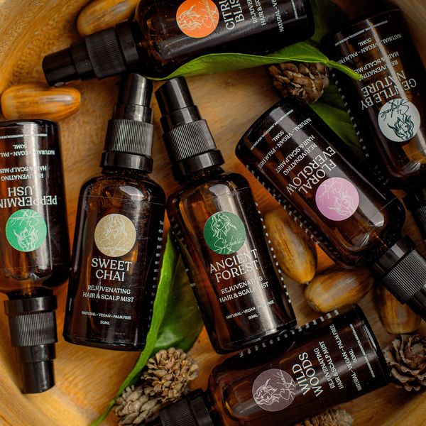 Haircare products arranged in a wooden bowl.
