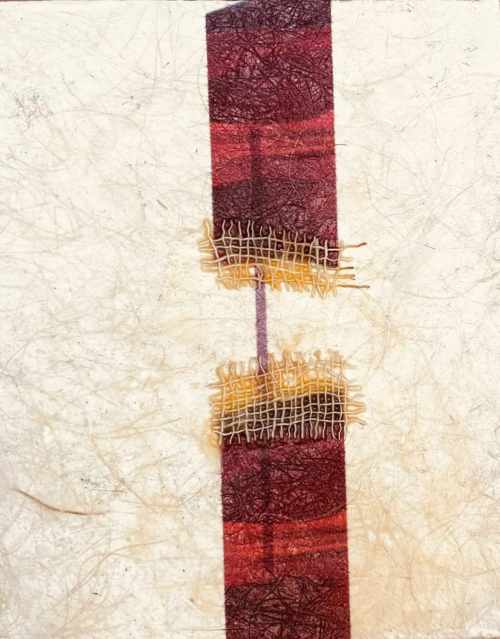 Abstract artwork with textured red strip and woven burlap on a light background.