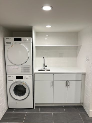 Cellar Laundry Room. Custom floating  stone shelf with concealed brackets/supports. Manhattan