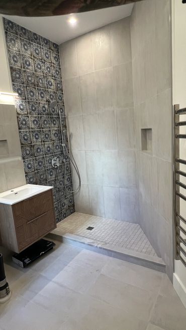 Harlem, NY Storage room turned in primary bathroom. concrete look tile via teh Tile Bar NYC with foc