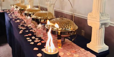 Romantic private dining table setup with candles and plated service