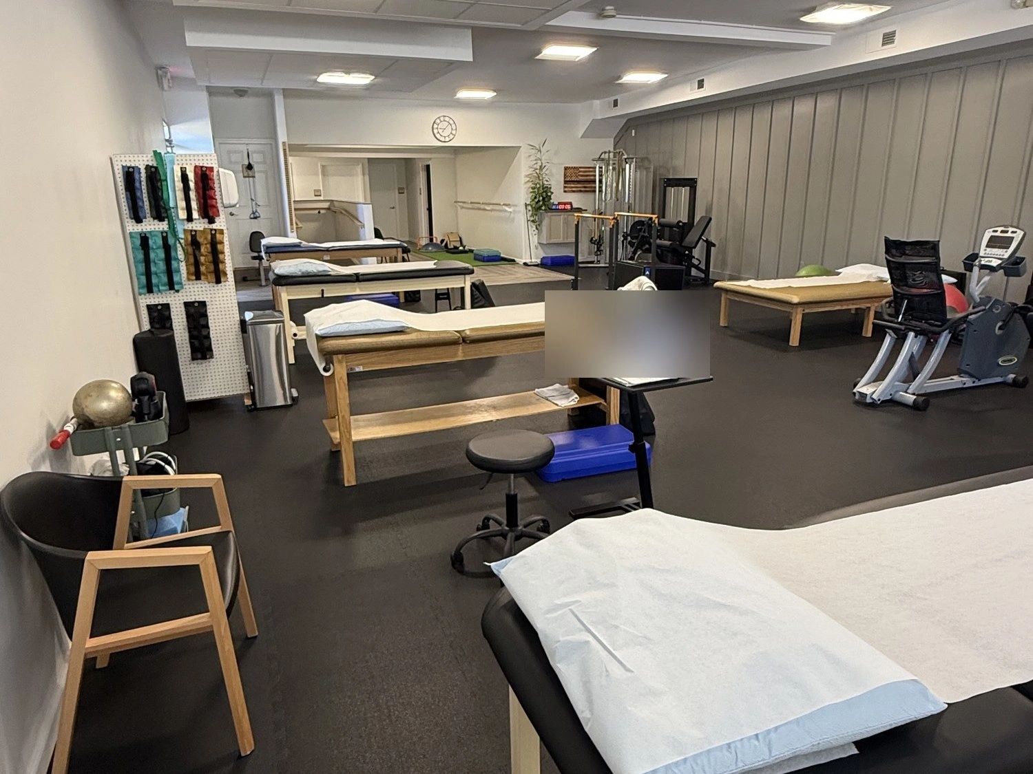Treatment tables and gym at BERG Physical Therapy in Howell, NJ
