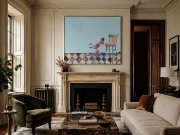 Elegant living room with classic decor and a modern painting.