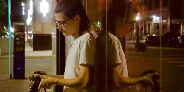 Photographer checking photos with nice reflection