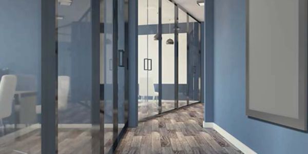Modern office hallway with glass doors and wooden floors.