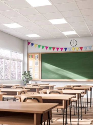 Bright and tidy empty classroom with wooden desks and a green chalkboard.
