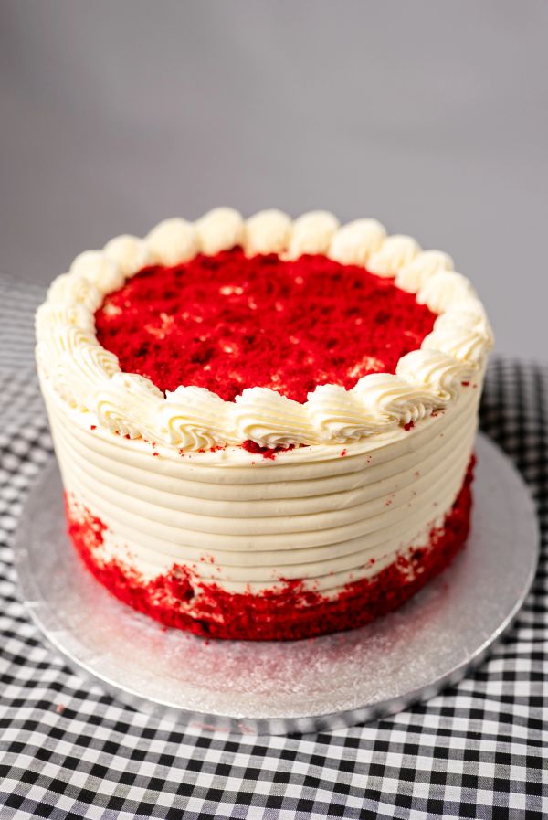 A red velvet cake with cream cheese frosting.