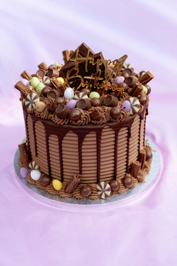 Chocolate birthday cake with colorful decorations.
