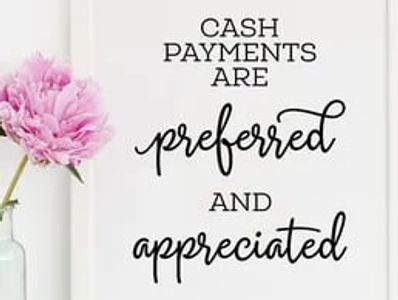 Pink flower in vase next to a cash payments sign