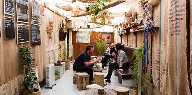 Interior shot of Satya Chai Lounge with group drinking some beers in covered courtyard 