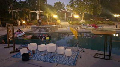 Evening poolside yoga or meditation setup with crystal singing bowls.
