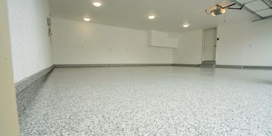 Completed garage floor with a seamless, flake finish using polyurea and polyaspartic for long last.