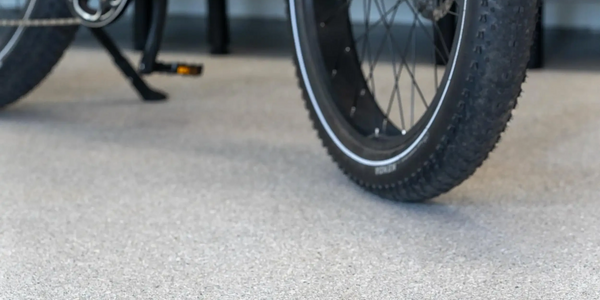 Close-up of a garage floor with a bicycle showcasing a seamless, durable, and stylish epoxy finish.