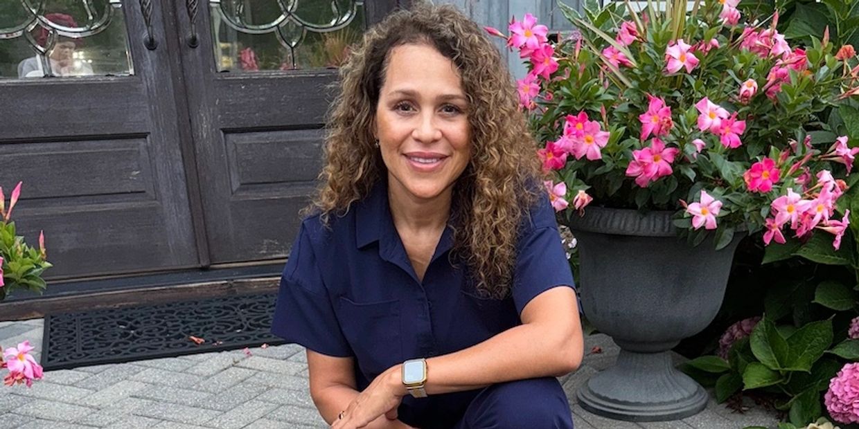 a woman with curly hair sitting on the stairs 
