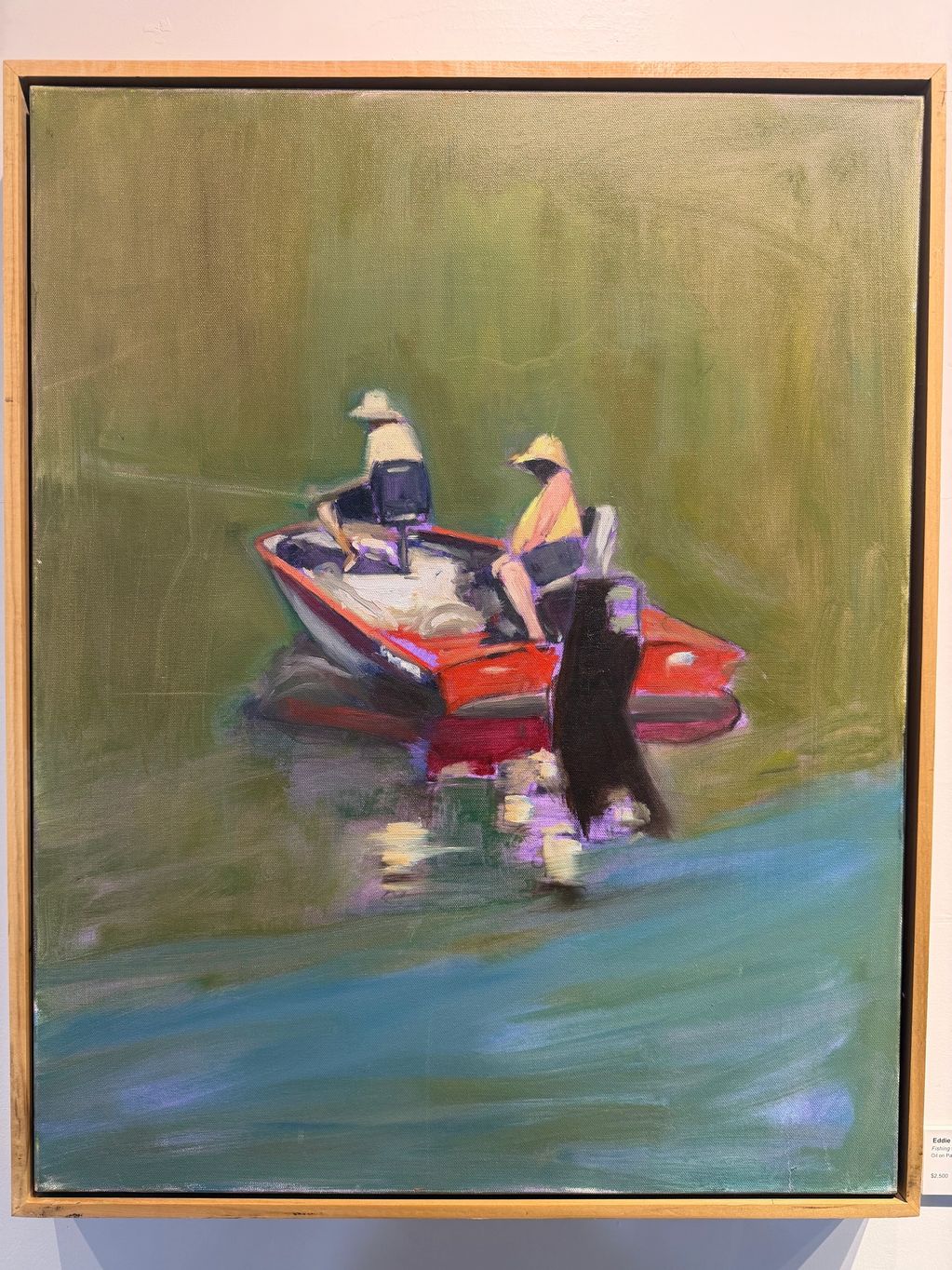 Two people fishing on a red boat in calm water.