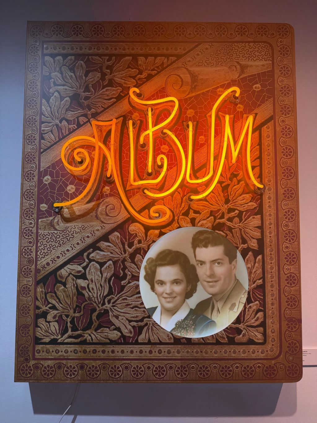 Vintage-style album cover with neon "ALBUM" text and a sepia photograph of a couple.