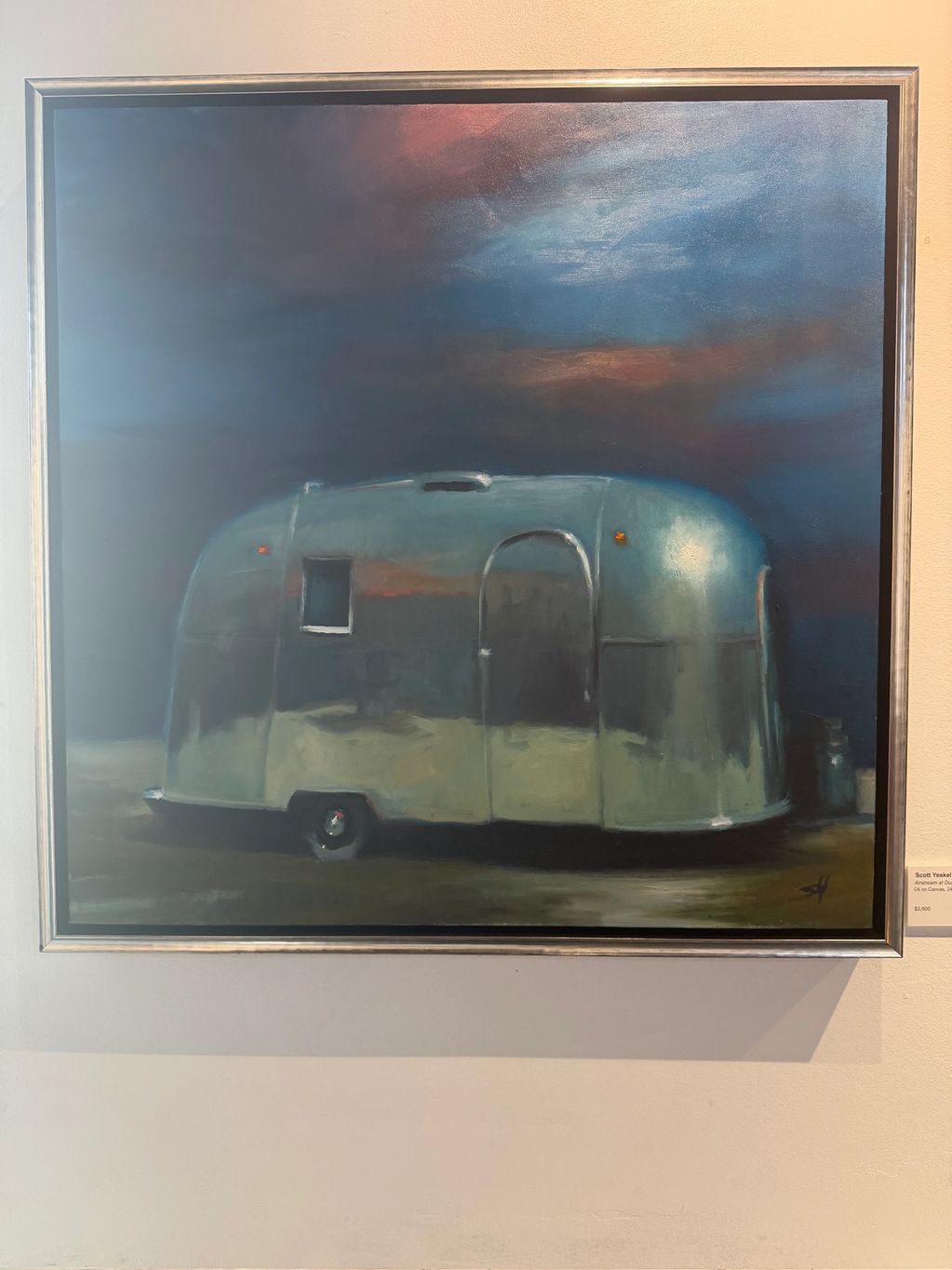 Painting of a vintage camper trailer under a moody sky.