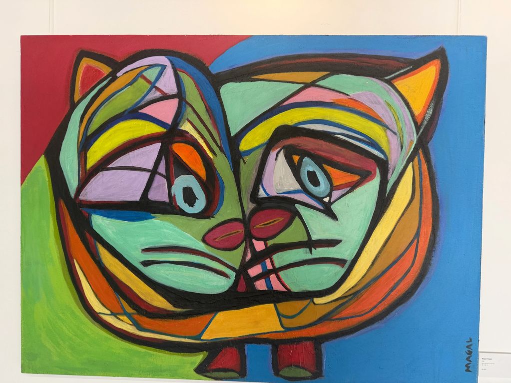 Colorful abstract painting of two cats in cubist style.