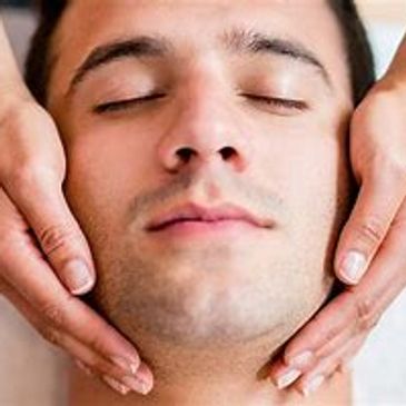 A Man Relaxing While Getting a Facial Done